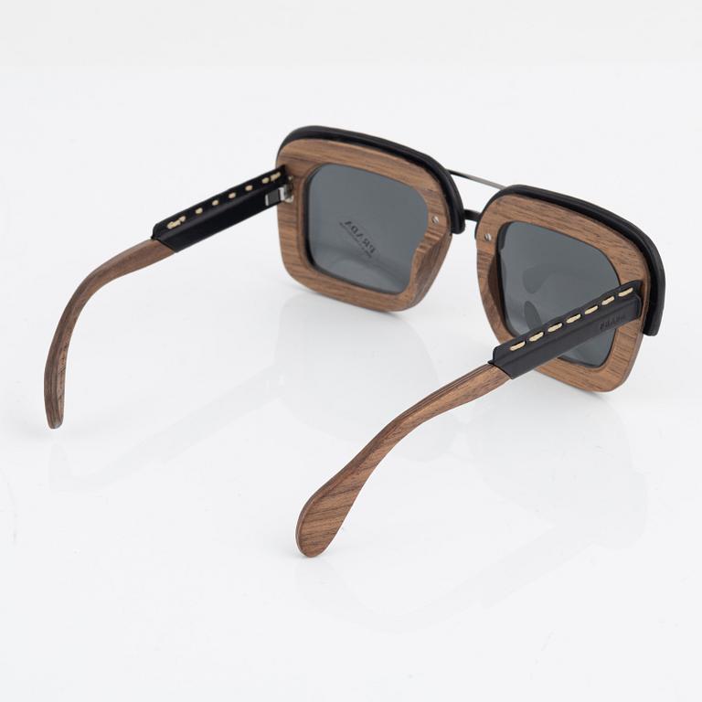 Prada, a pair of wood and leather sunglasses.