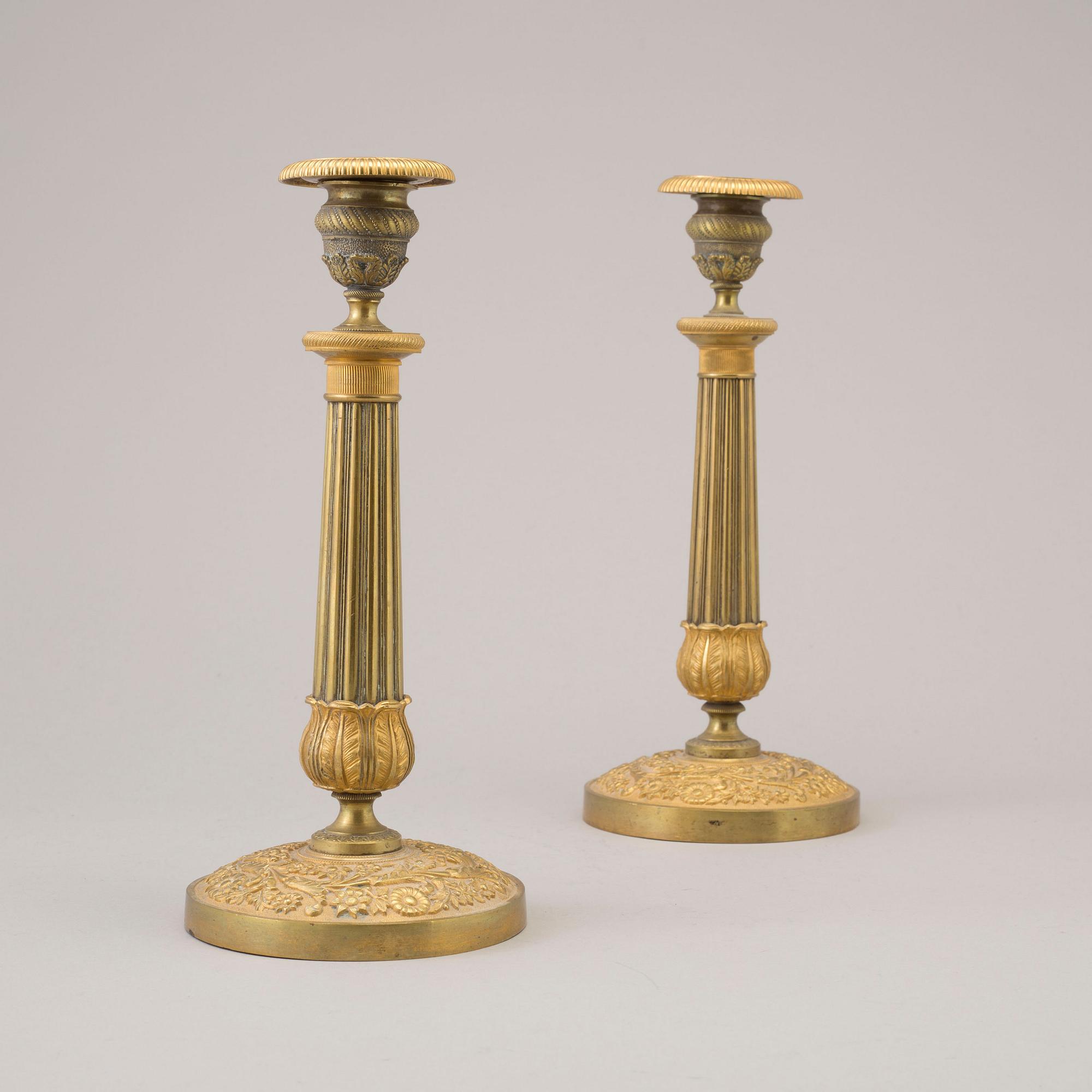 A pair of early 19th century ormolu candlesticks.