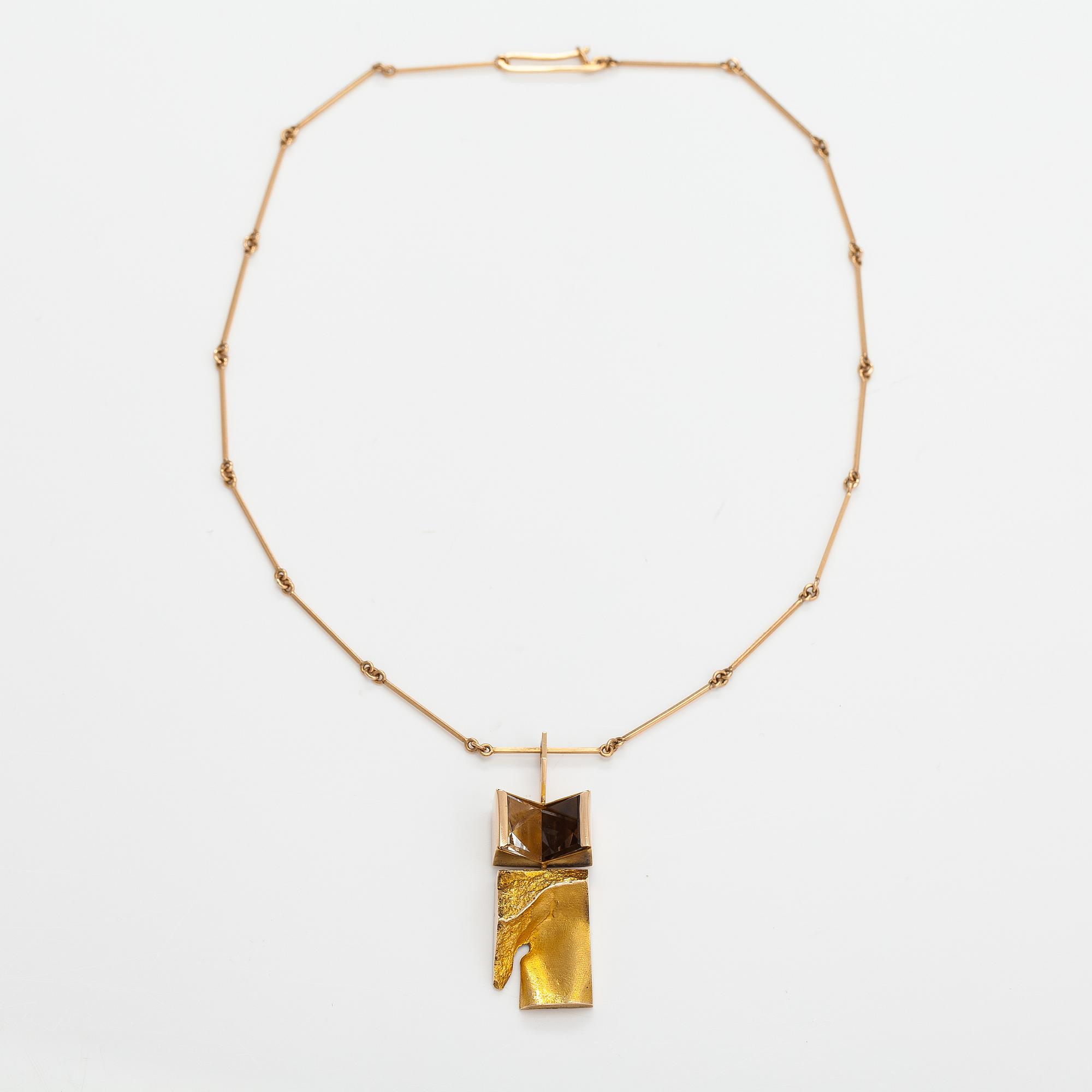 Björn Weckström, "Narcissos", a 14K gold pendant with a smoaky quartz and a rock crystal. Lapponia 1965.