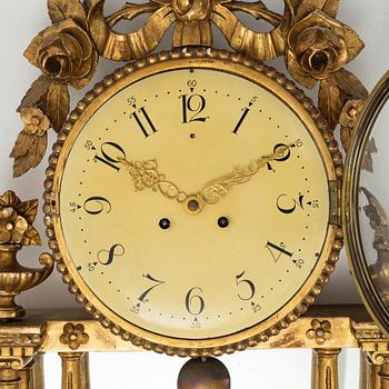 A  late Gustavian style wall clock, early 20th century.