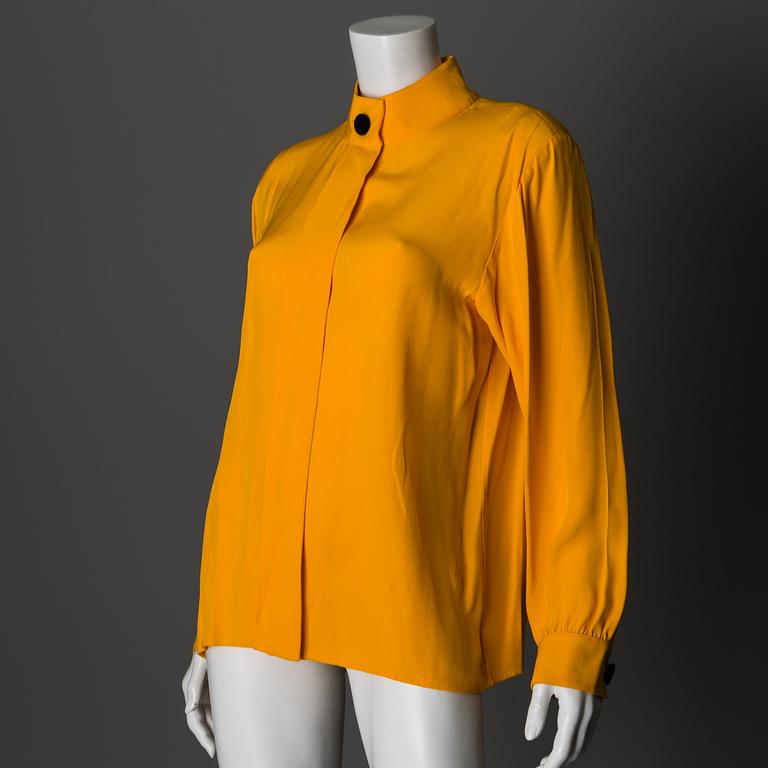 A blouse by Yves Saint Laurent, size 42 (FR).