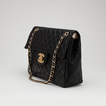 CHANEL, a quilted black leather shoulder bag, "Flap bag maxi".