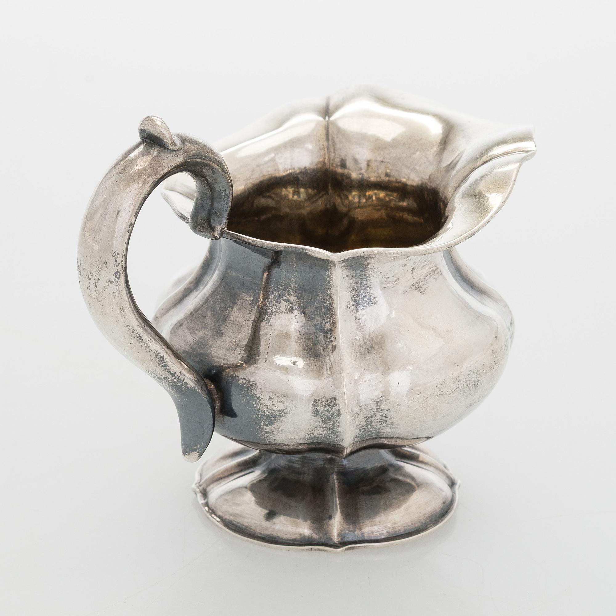 A silver cream jug, maker's mark of Michael Takkinen, St. Petersburg 1856.