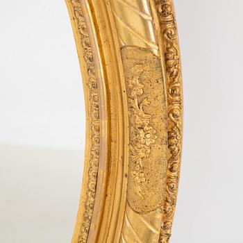 An oval mirror from around the year 1900.