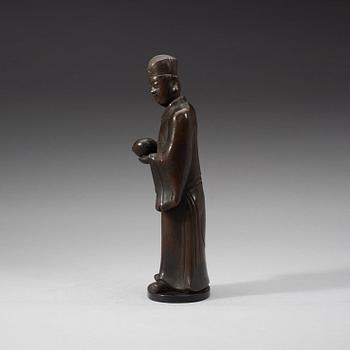 A bronze figure of a Mandarin official with a box, Qing dynasty, 19th Century.