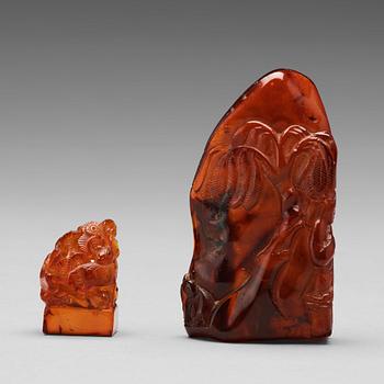 505. Two Chinese carved amber sculptures, 20th century.