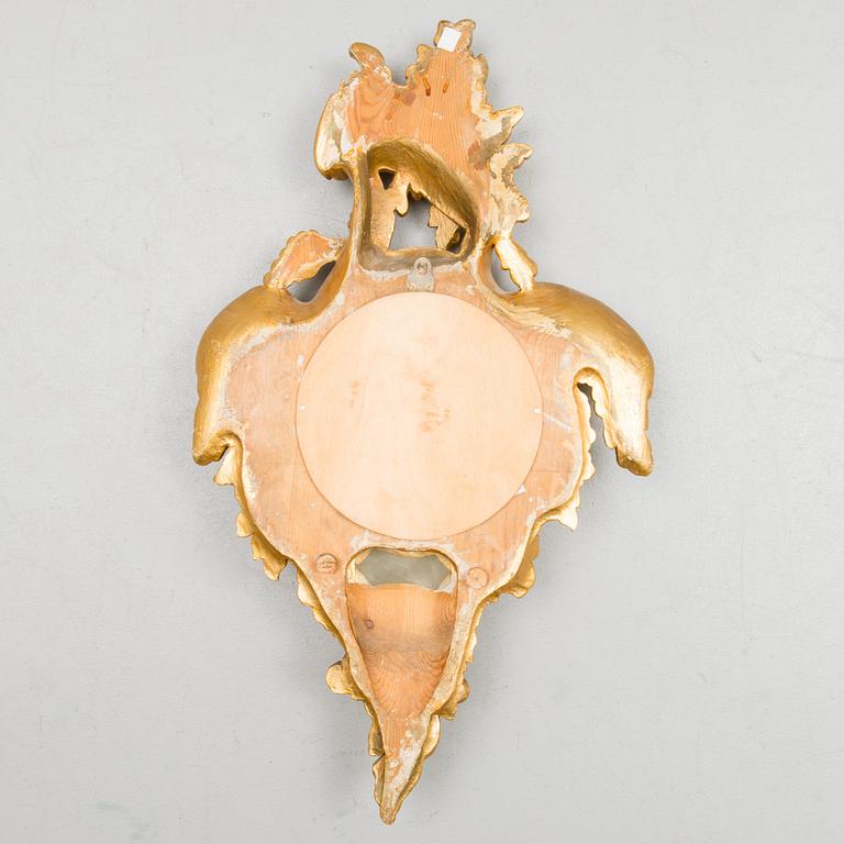 A Rococo-style pendulum wall clock from the 20th century.