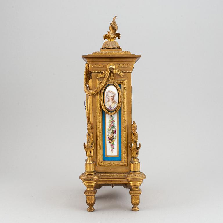 A late 19th century table clock and candelabra, probably France.
