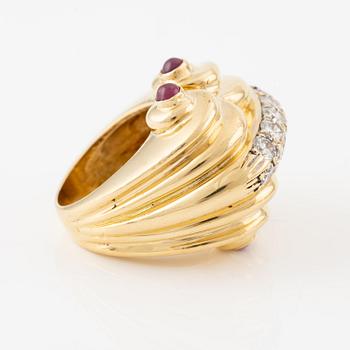 An 18K gold ring set with round brilliant-cut diamonds and cabochon-cut rubies.