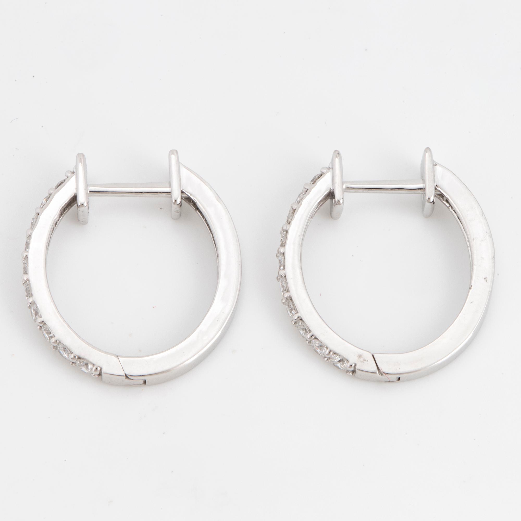 Brilliant-cut diamond hoop earrings.