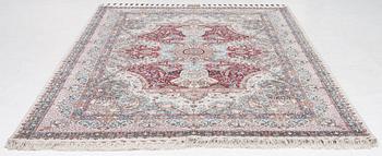 A Tabriz carpet, 210 x 195 cm. signed.