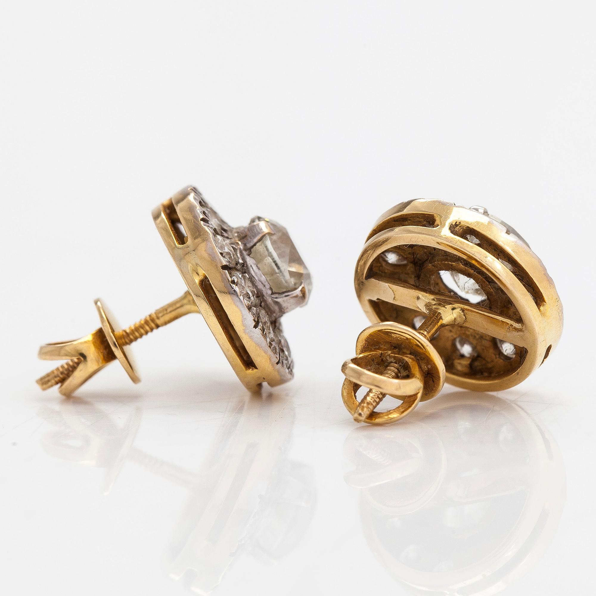 A pair of 18K white/yellowgold earrings set with brilliant cut diamonds approx. 3.40 ct in total. With certificate.