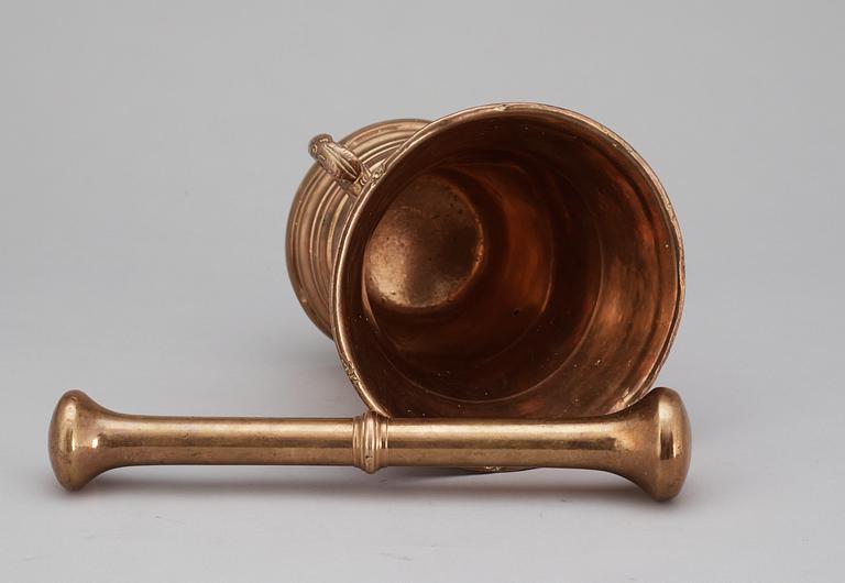 A 18th century brass mortar with pestle.