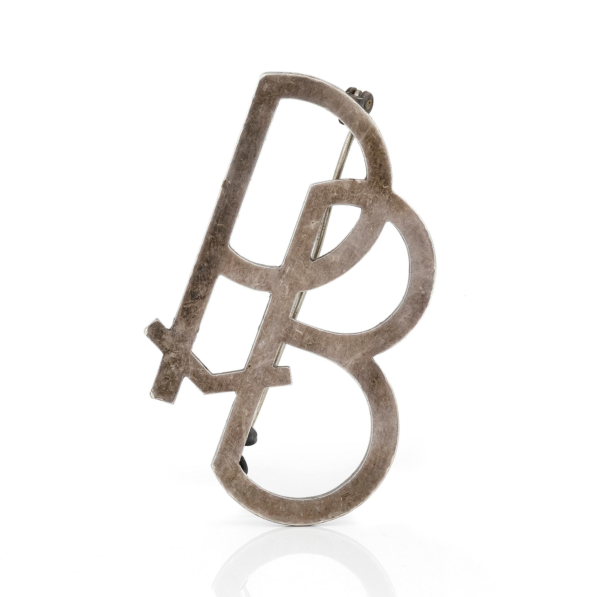 MONOGRAMBROSCH, sterling silver, signerad Wiwen Nilsson, 1938. Totalvikt ca 12 g.