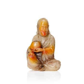 1135. A Chinese carved nephrite sculpture of a man, 20th Century.
