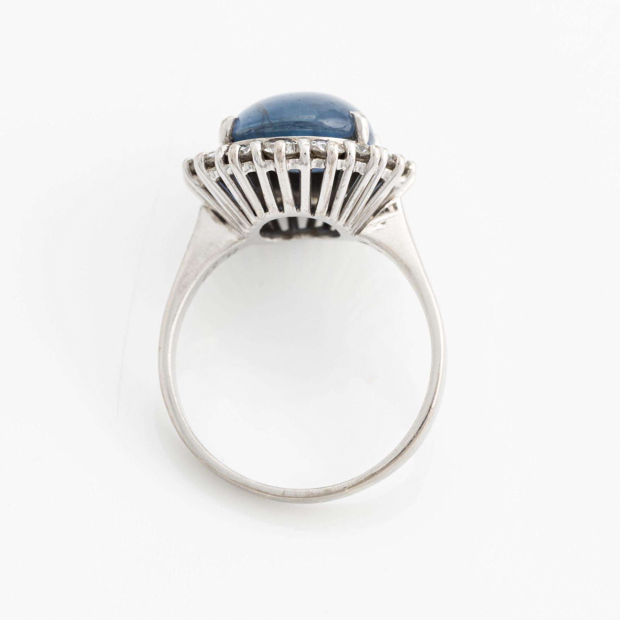 Ring with cabochon-cut sapphire and brilliant-cut diamonds.