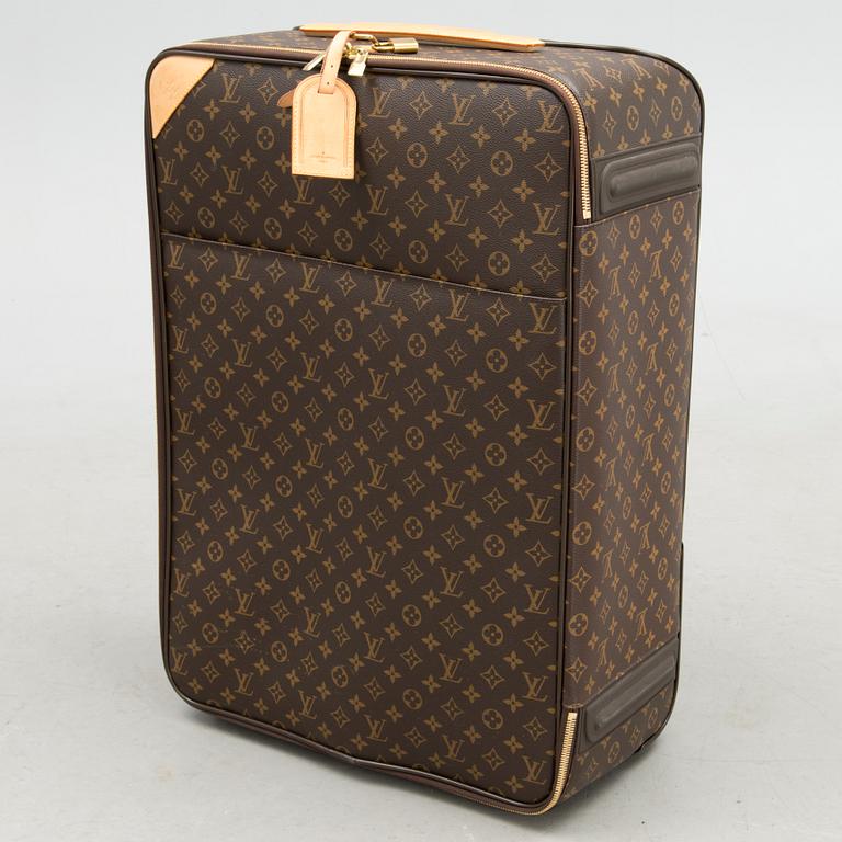 A Monogram Canvas Pégase 65 Suitcase with a Protective Cover.