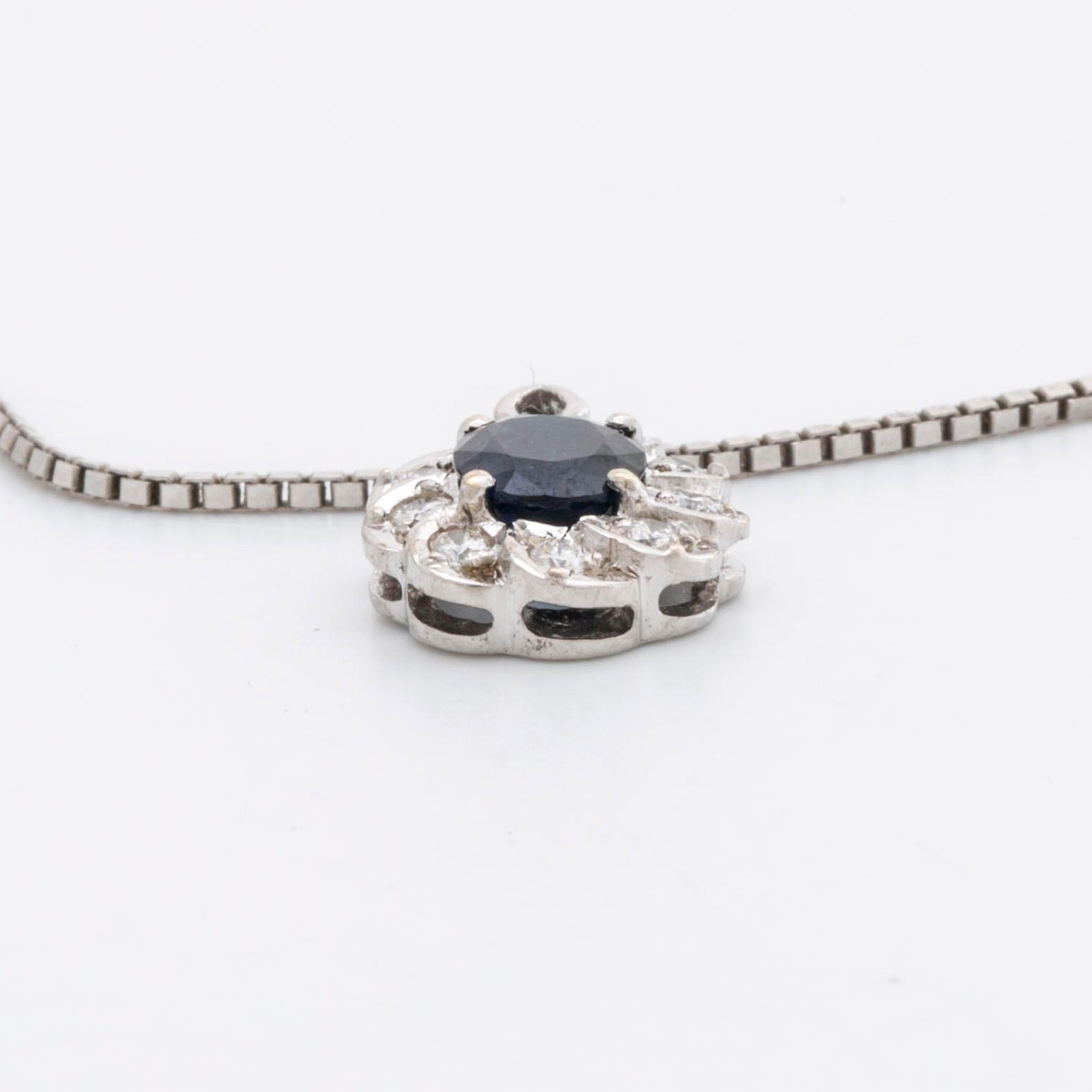 PENDANT and chain 18K whitegold 1 sapphire approx 6 x 4 mm and brilliant-cut diamonds approx 0,25 ct in total.