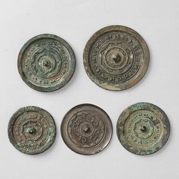 A group of five bronze mirrors, Han dynasty.