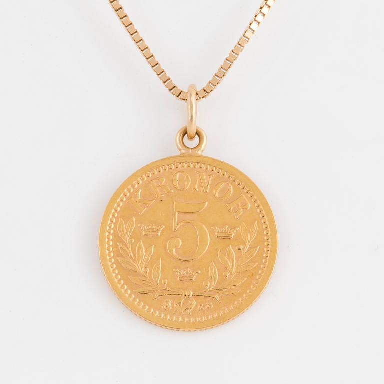 A goldcoin with 18K gold chain.