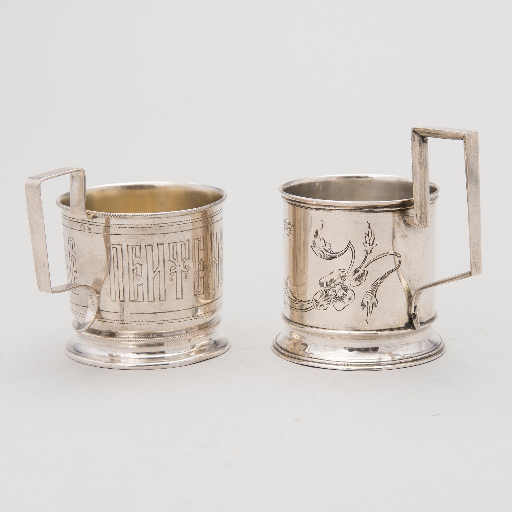 Two tea glass holders in silver, one with mark of Ivan Saltykov, Moscow 1889, the other one marked Moscow 1908-1917.