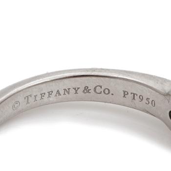 A ring set with a round, brilliant-cut diamond by Tiffany & Co.