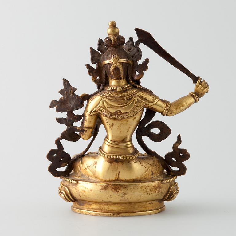 SKULPTUR, "Manjushri", förgylld metallegering, Tibet 1900-talets mitt.