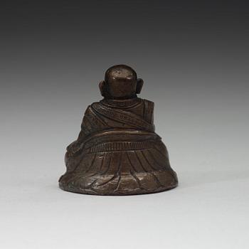 A copper alloy figure of a Lama, Tibet, 18th Century.