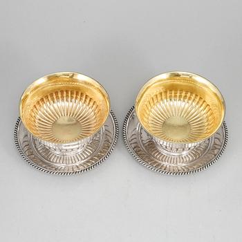 A pair of Swedish 19th century parcel-gilt silver sauce-bowls and plats, marked JP Gronvall, Stockholm 1835.