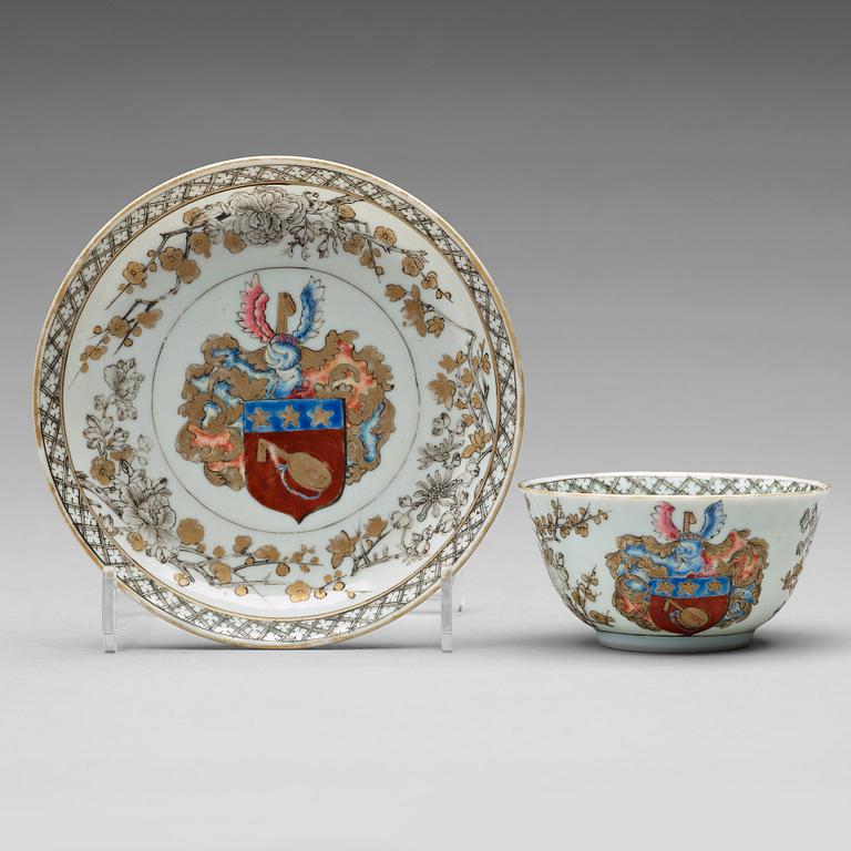 A famille rose armorial cup with saucer, Qing dynasty, 18th Century.