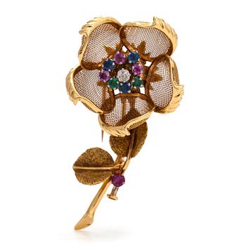An 18K gold "en tremblant" flower brooch set with a diamond, rubies, sapphires, and emeralds. French hallmarks.