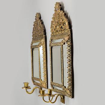 An early 20th Century pair of baroque style mirror sconses.