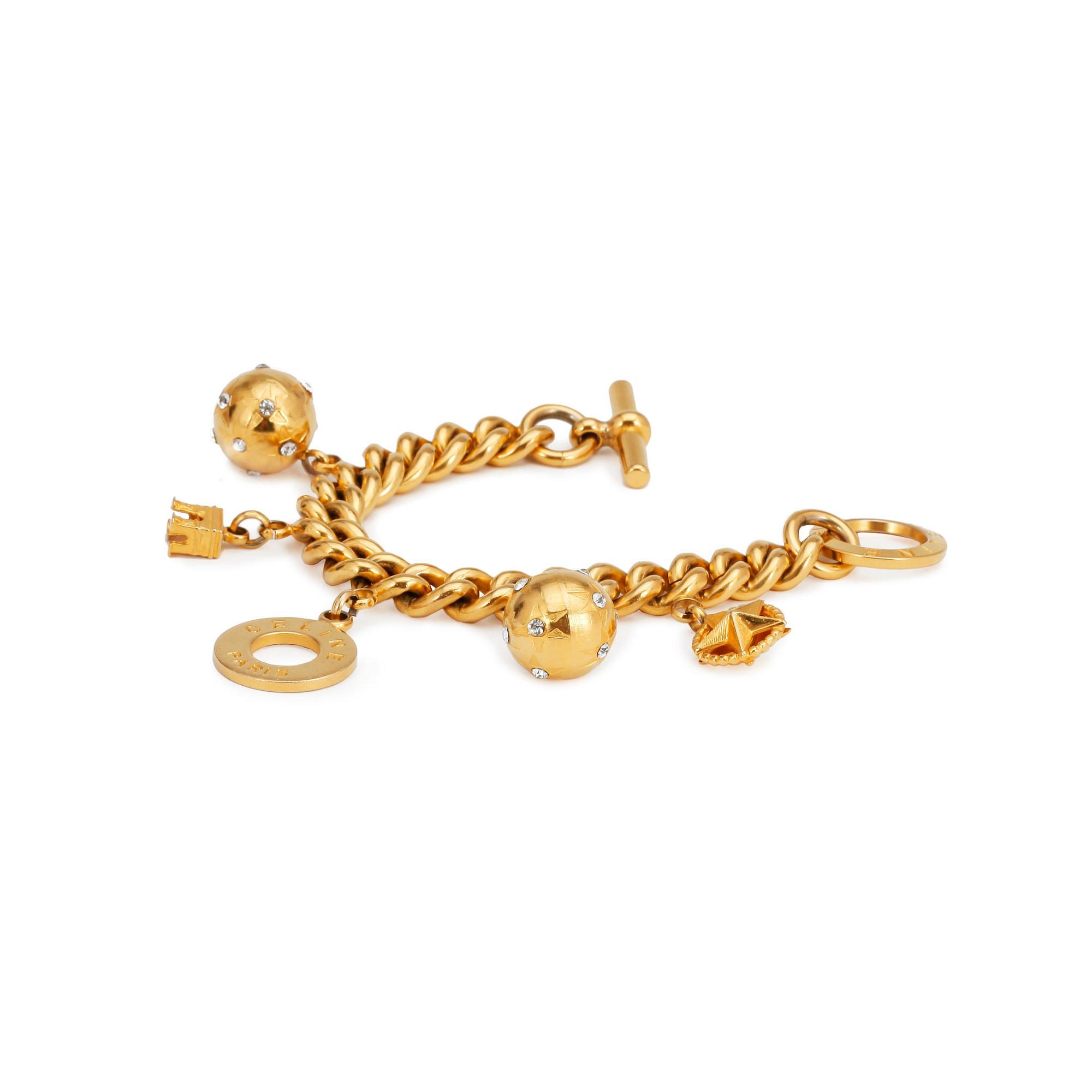 CÉLINE, a gold colored charm bracelet.