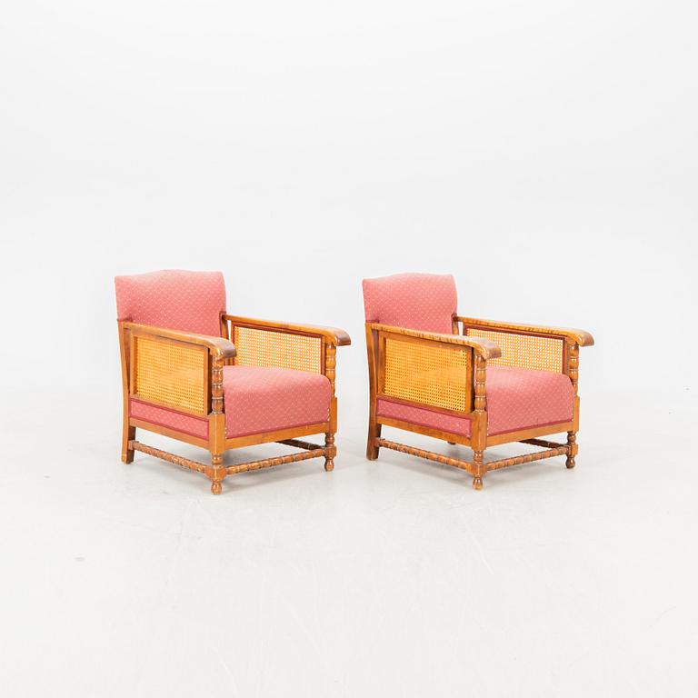 A pair of lacquered wood and rattan easy chairs from the middle of the 20th century.