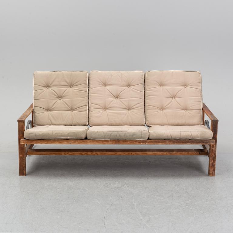 A stained pine garden sofa by Elsa Stackelberg.