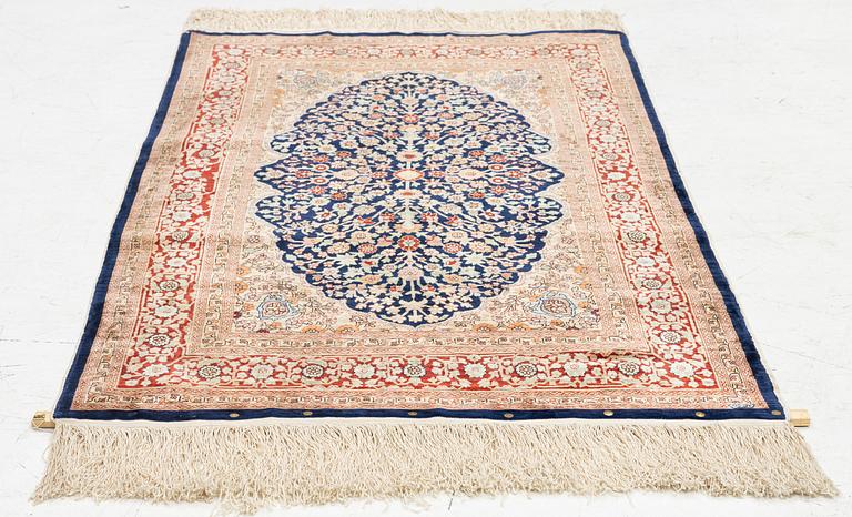 A Hereke silk rug, c. 130 x 71 cm.