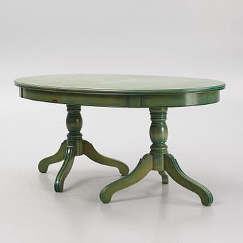 A dining table with eight chairs, Grange, France, late 20th century.