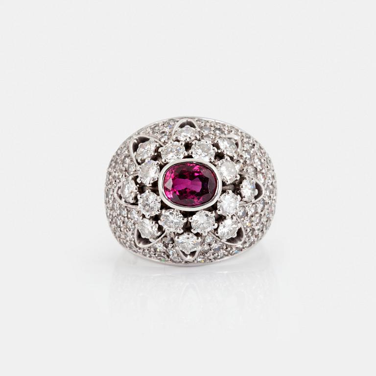 A RING set with an oval mixed-cut ruby and round brilliant- and eight-cut diamonds.