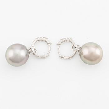 A pair of 18K gold earrings with cultured Tahitian pearls and round brilliant-cut diamonds.