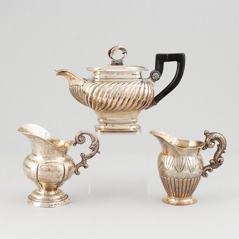 A mixed lot of two 19th century silver and parcel-gilt creamers and a coffee-pot.