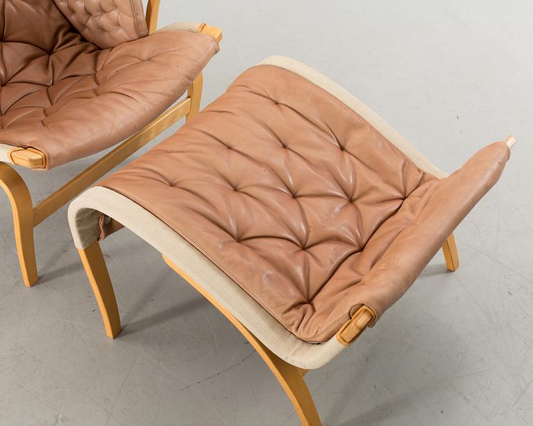 A "PERNILLA" ARMCHAIR WITH OTTAMAN BY BRUNO MATHSSON BY DUX.