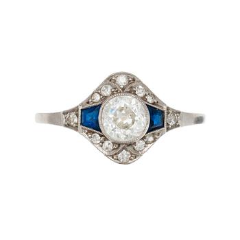 381. A RING, 18K gold, platinum. Old cut diamonds c. 0.75 ct  Center stone c. 0.65 ct vs, sapphires c. 0.40 ct .