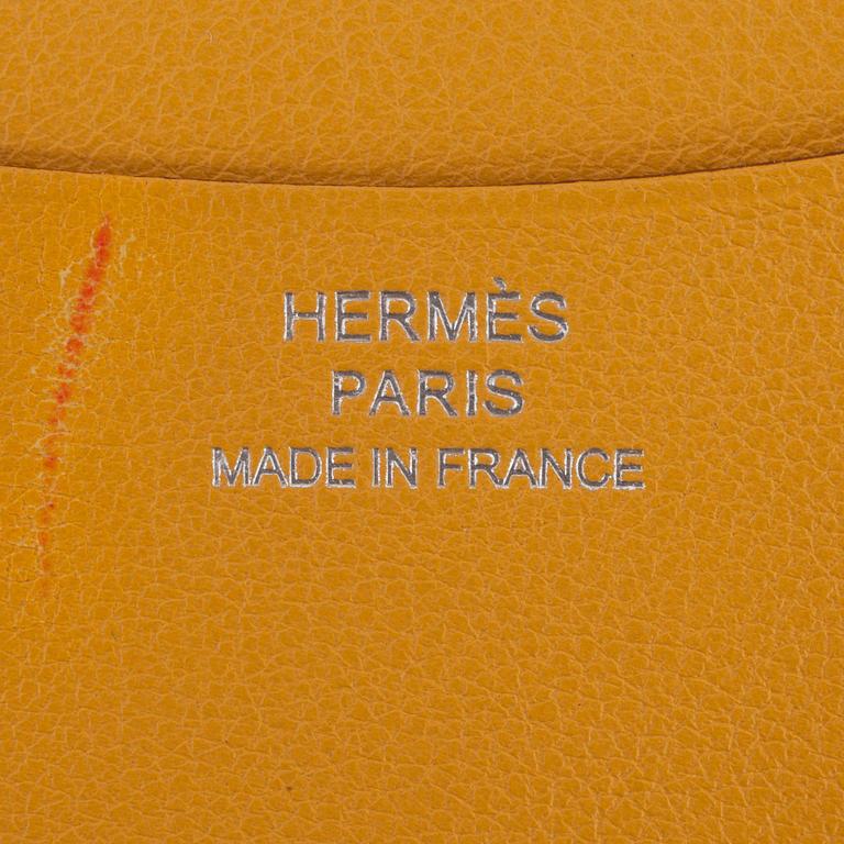HERMÈS, a yellow leather agenda cover, "Globe Trotter".
