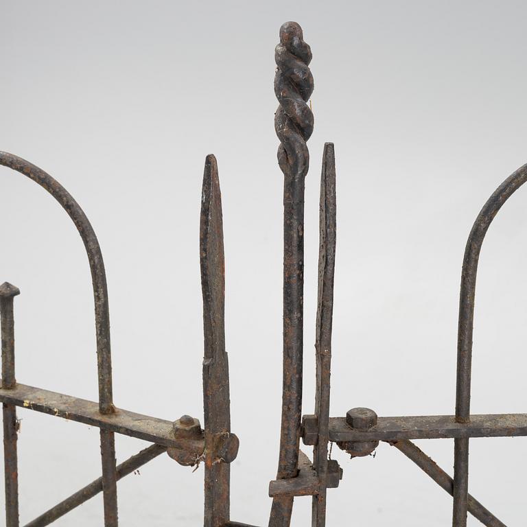 A pair of iron garden gates and a single gate from the early 20th century.