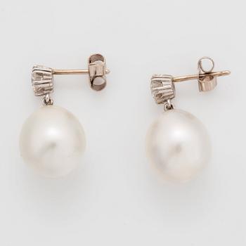 A pair of 18K white gold earrings set with round brilliant-cut diamonds and cultured pearls.