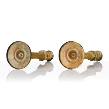 A pair of French Empire ormolu candlesticks, ca 1820's.