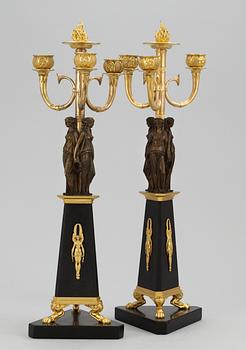 A pair of French Empire three-light candelabra.