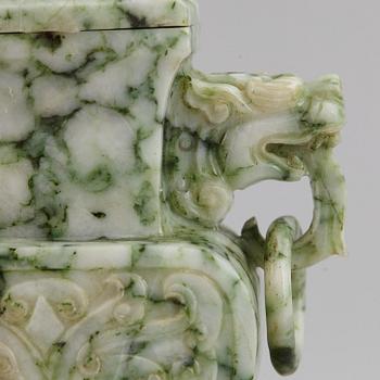 A carved green stone vase with cover, China, 20th Century.