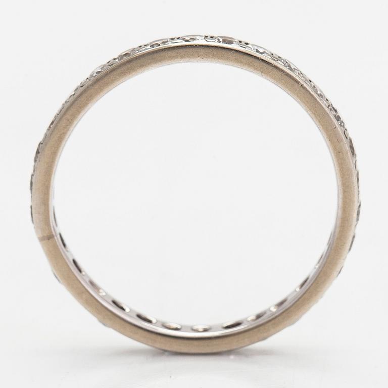 An 18K white gold eternity ring with brilliant-cut diamonds totalling approximately 0.60 ct.