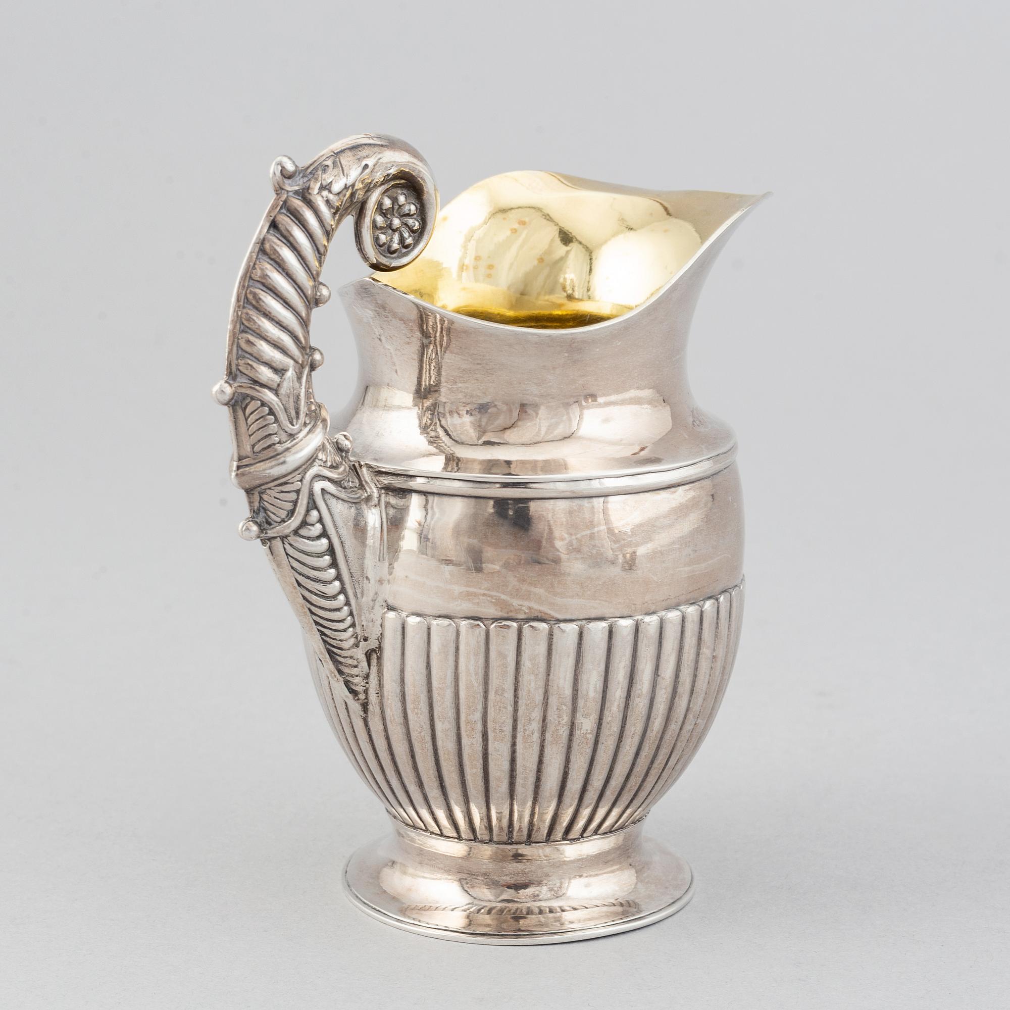 A silver creamer by Johan Petter Ahlforss, Strängnäs, 1833 and a silver sugar box, Kristianstad, 1928.